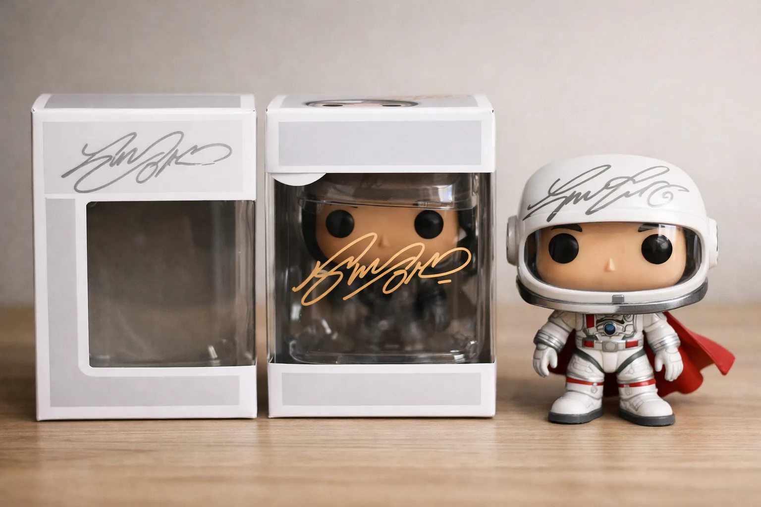 Trois Funko Pop montrent des dédicaces placées sur le carton, la fenêtre transparente et le vinyle.